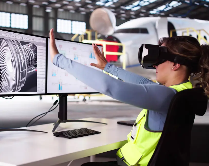 Person using VR for aircraft engine design.