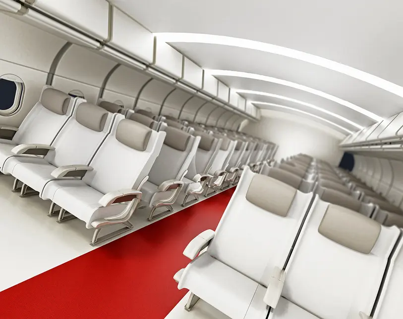 Airplane interior with empty white seats.