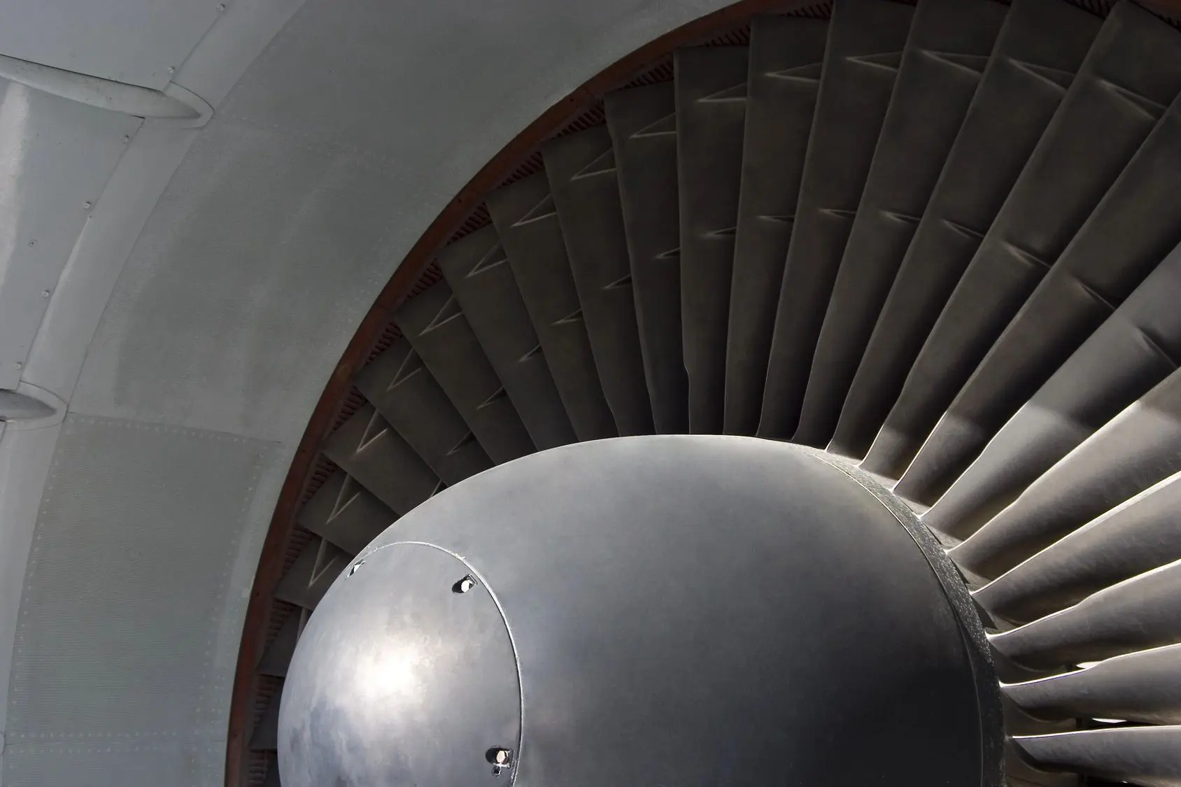 Close-up of a jet engine turbine with blades.